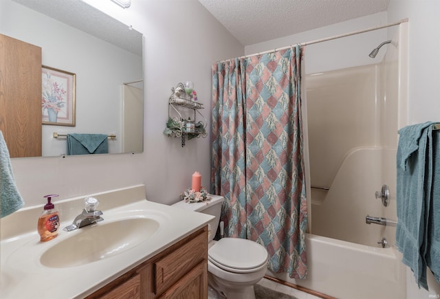 bathroom featuring shower / bath combo with shower curtain, a textured ceiling, vanity, and toilet