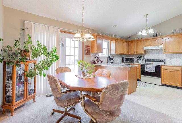 dining area featuring visible vents, a notable chandelier, light colored carpet, and vaulted ceiling