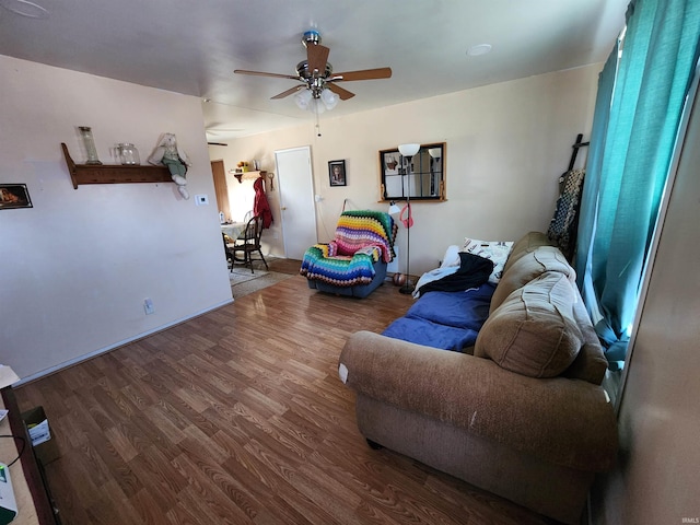 living area featuring wood finished floors and ceiling fan