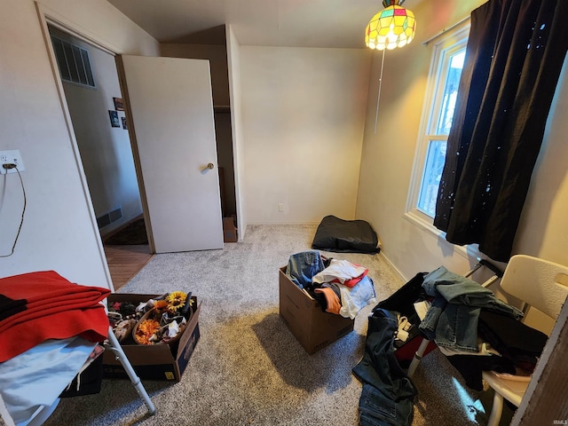 bedroom with visible vents and carpet flooring