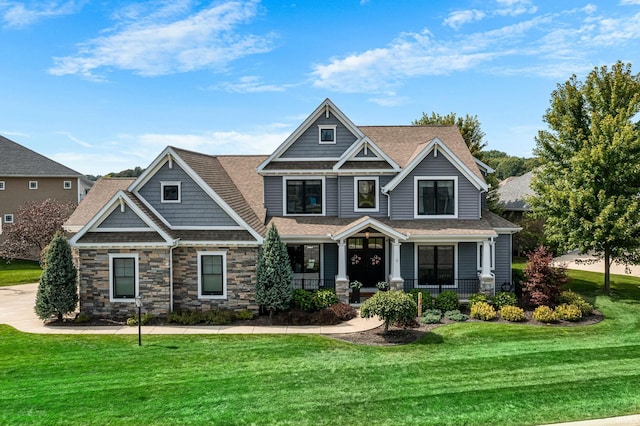 craftsman house with a front yard and covered porch