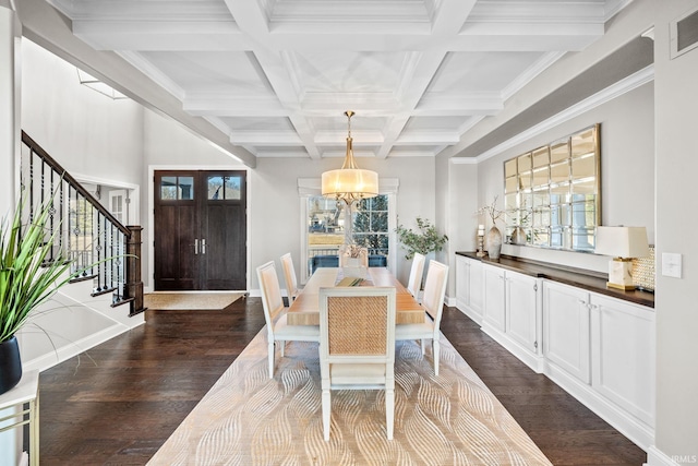 dining space with a chandelier, dark wood-style floors, a healthy amount of sunlight, and beamed ceiling