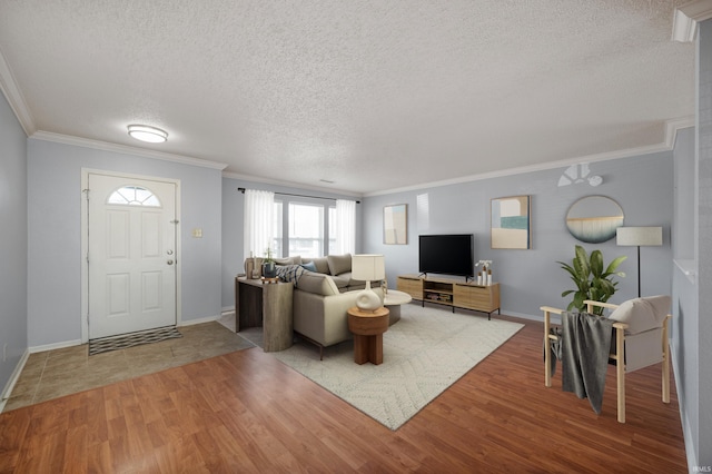 living room featuring a textured ceiling, wood finished floors, and ornamental molding