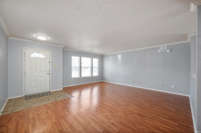 entryway with a textured ceiling, light wood-style flooring, baseboards, and ornamental molding