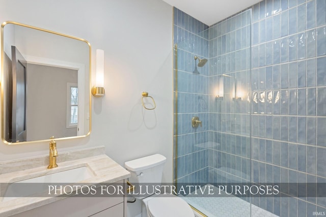 bathroom featuring vanity, toilet, and a tile shower