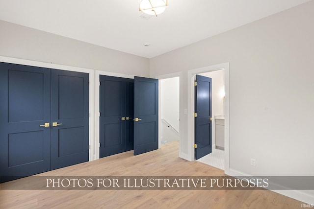 620 N Notre Dame Ave, South Bend, IN 46617 - unfurnished bedroom with wood finished floors, two closets, and ensuite bathroom