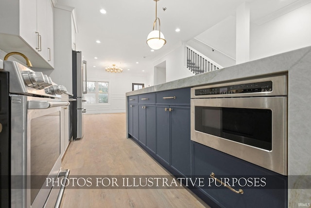 kitchen with light wood-type flooring, pendant lighting, recessed lighting, stainless steel appliances, and white cabinets