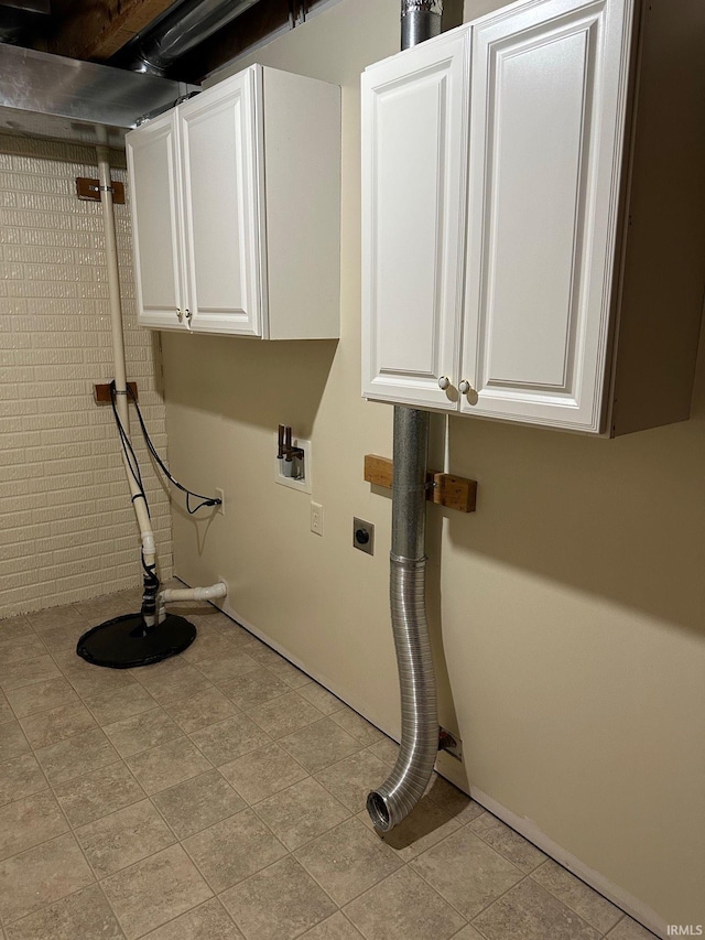 clothes washing area with electric dryer hookup, cabinet space, and washer hookup