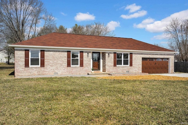 ranch-style home with driveway, an attached garage, a front yard, crawl space, and brick siding