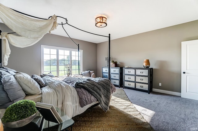 bedroom featuring carpet and baseboards