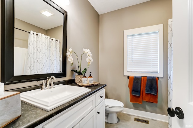 bathroom featuring visible vents, baseboards, toilet, tile patterned floors, and vanity