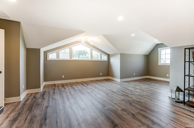 additional living space with lofted ceiling, wood finished floors, and baseboards