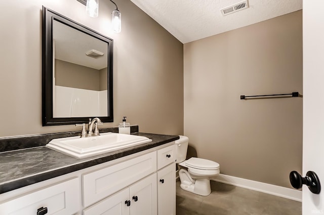 bathroom with visible vents, baseboards, toilet, vanity, and a textured ceiling