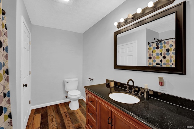 full bath featuring baseboards, toilet, wood finished floors, and vanity