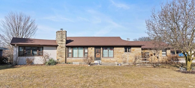 view of front facade featuring stone siding, a front lawn, and a chimney