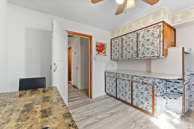 interior space featuring brown cabinetry, a ceiling fan, and light wood finished floors