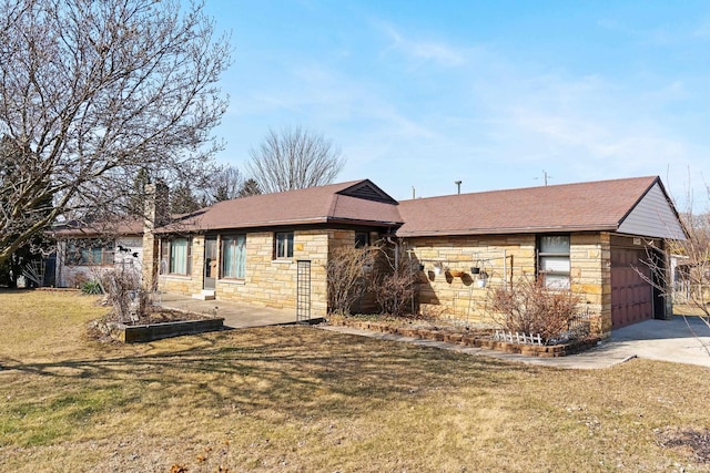 ranch-style house with stone siding, an attached garage, concrete driveway, and a front yard