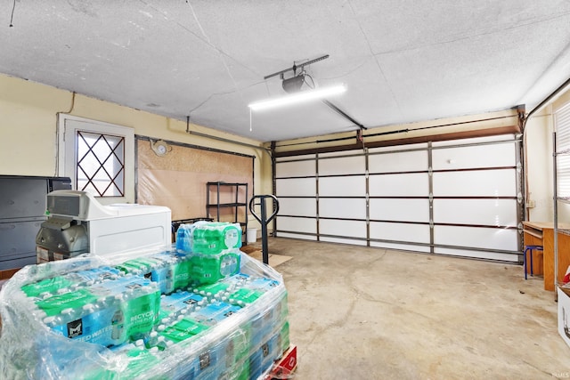 garage with washer / clothes dryer and a garage door opener