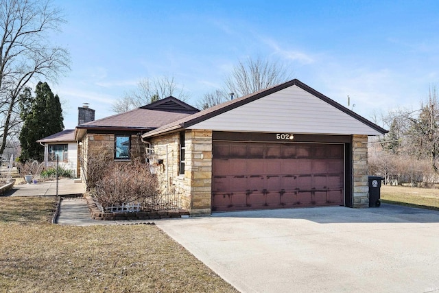 single story home with driveway, stone siding, an attached garage, a front yard, and a chimney