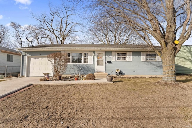 ranch-style home featuring an attached garage and concrete driveway