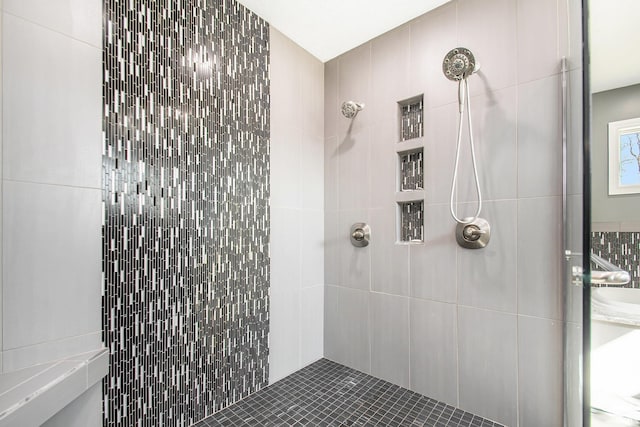 bathroom with tiled shower