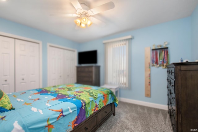 carpeted bedroom with baseboards, multiple closets, and ceiling fan