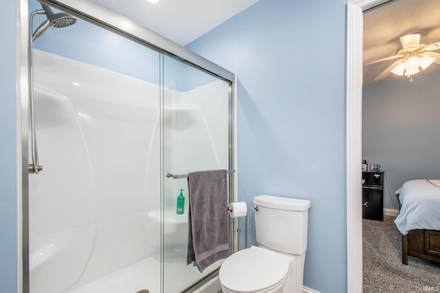 bathroom with baseboards, toilet, a stall shower, ensuite bath, and a ceiling fan