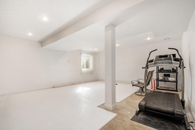 exercise room with recessed lighting and baseboards