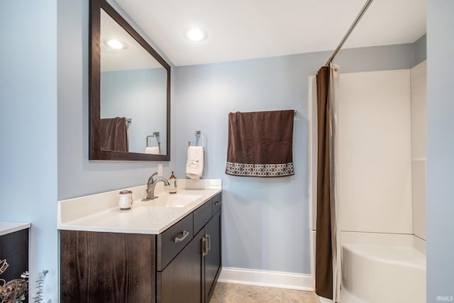 full bathroom with recessed lighting, vanity, baseboards, and shower / bath combo