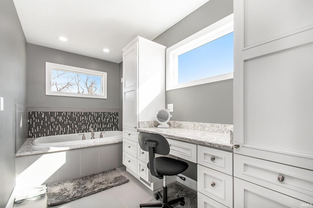 full bath with a bath, plenty of natural light, recessed lighting, and vanity