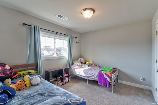 carpeted bedroom with visible vents and baseboards