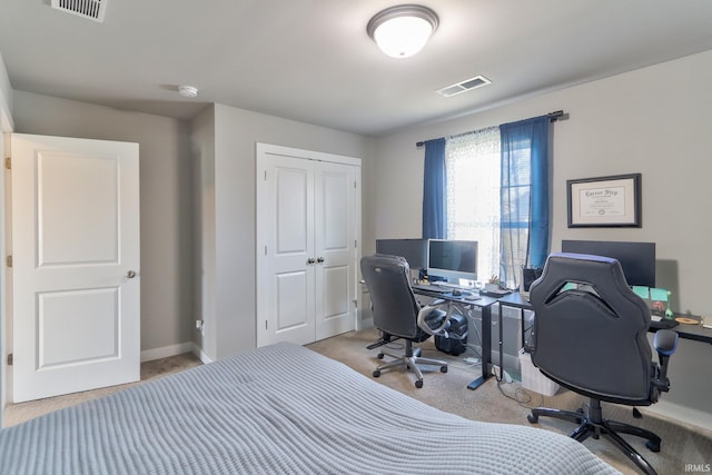 bedroom featuring a closet, baseboards, visible vents, and carpet floors