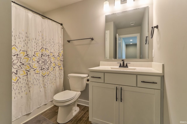 bathroom with visible vents, baseboards, toilet, wood finished floors, and vanity