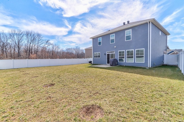 rear view of property with a yard, a patio, and a fenced backyard