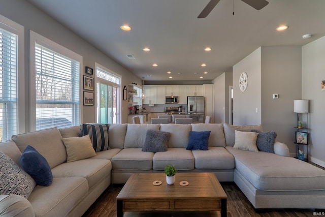 living room featuring a ceiling fan, dark wood-type flooring, recessed lighting, and visible vents