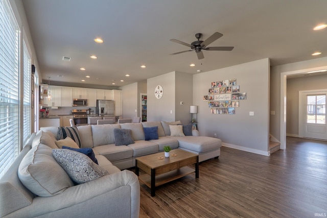 living area featuring visible vents, dark wood-style floors, recessed lighting, baseboards, and stairs