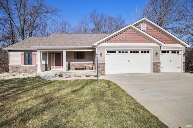 craftsman inspired home featuring a garage, stone siding, covered porch, and a front lawn