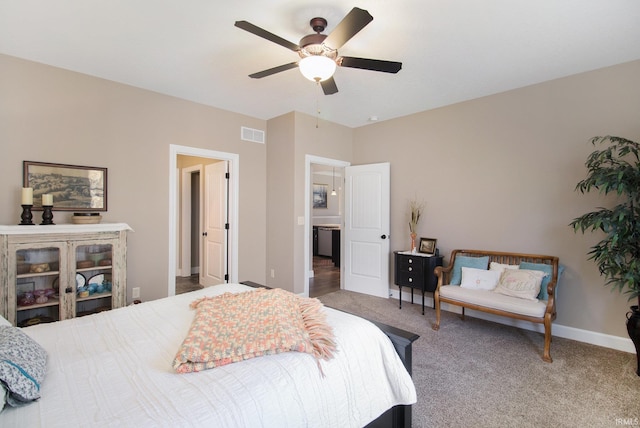 carpeted bedroom featuring visible vents, baseboards, and ceiling fan