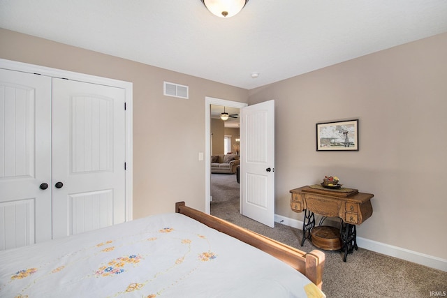 bedroom with carpet, visible vents, a closet, and baseboards