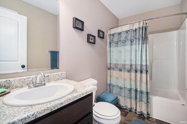 full bathroom with vanity, stone finish floor, toilet, and shower / tub combo with curtain