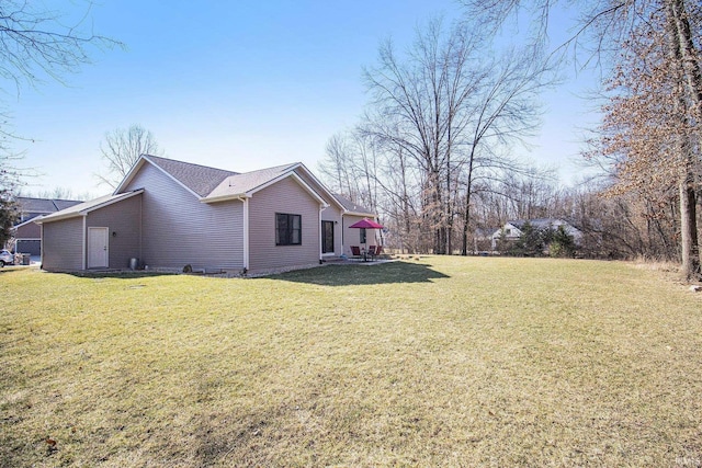 view of side of home featuring a lawn