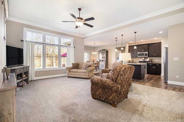 living room featuring baseboards, recessed lighting, ceiling fan, crown molding, and dark carpet