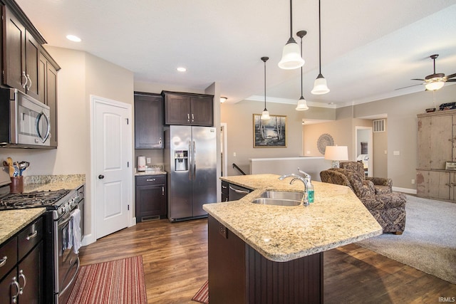 kitchen featuring visible vents, a sink, stainless steel appliances, dark brown cabinetry, and open floor plan