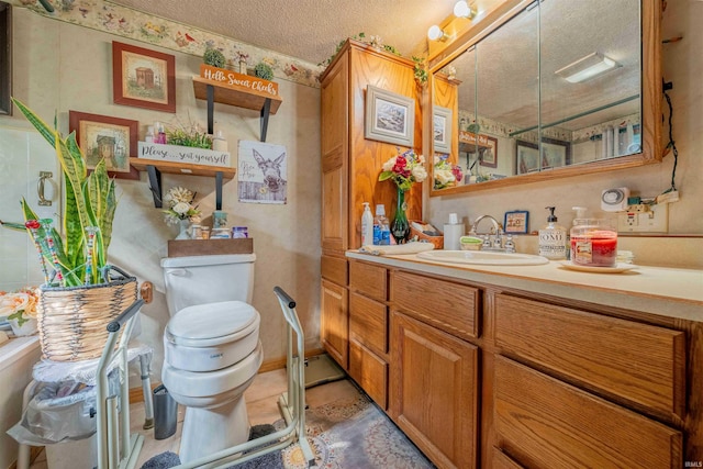 bathroom with tile patterned floors, a textured ceiling, toilet, and vanity