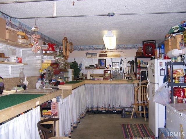 2685 S Knoll Dr, Macy, IN 46951 - kitchen with concrete flooring and freestanding refrigerator