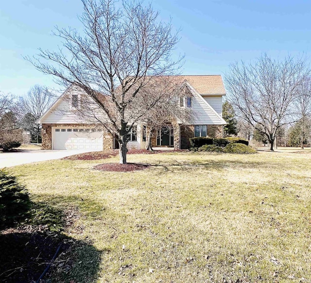 view of front of house featuring a garage, driveway, and a front lawn