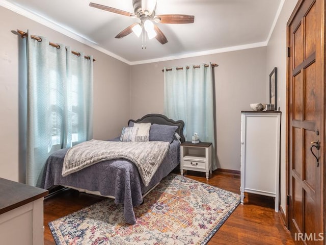 bedroom featuring dark wood finished floors, baseboards, a ceiling fan, and ornamental molding