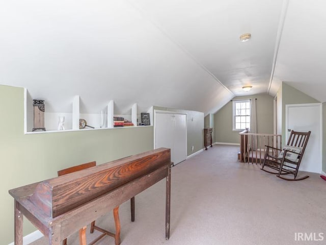 office space featuring baseboards, lofted ceiling, and carpet