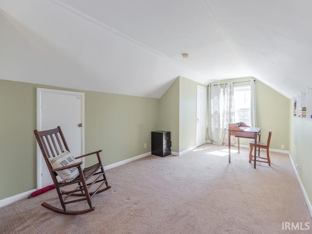 sitting room featuring baseboards, carpet flooring, and vaulted ceiling