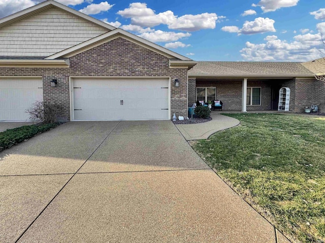 single story home with a garage, driveway, brick siding, and a front lawn